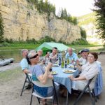 Guests enjoying dinner at camp on the Smith River