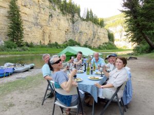 Guests enjoying dinner at camp on the Smith River