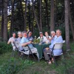 Guests enjoying dinner at camp on the Smith River