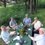 Guests enjoying some wine and relaxing at camp on the Smith River