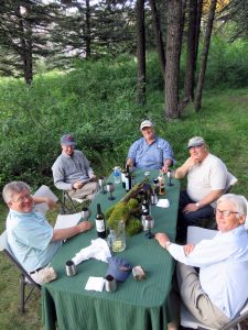 Guests enjoying some wine and relaxing at camp on the Smith River