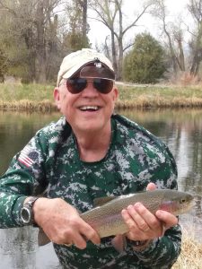 Guest holding a Rainbow trout