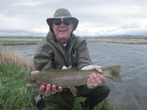 Guest holding a Rainbow trout