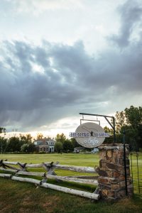 Signage & lush landscape at Healing Waters Lodge