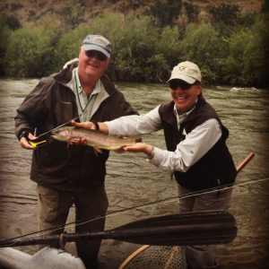 Healing Waters Lodge guests with a rainbow trout